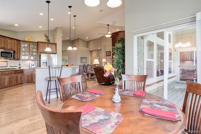 14879 Xenia St, Thornton, CO 80602 - dining room with light wood finished floors, ceiling fan, recessed lighting, french doors, and high vaulted ceiling
