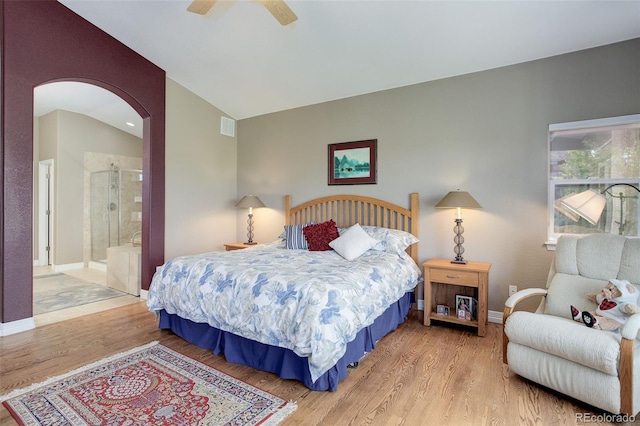 14879 Xenia St, Thornton, CO 80602 - bedroom featuring arched walkways, wood finished floors, connected bathroom, vaulted ceiling, and a ceiling fan