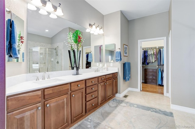 14879 Xenia St, Thornton, CO 80602 - full bathroom featuring a spacious closet, a shower stall, double vanity, tile patterned floors, and lofted ceiling