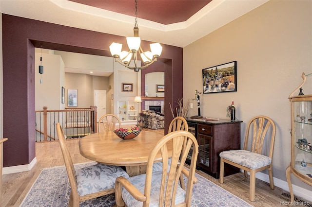 14879 Xenia St, Thornton, CO 80602 - dining space with a chandelier, light wood-style floors, and baseboards