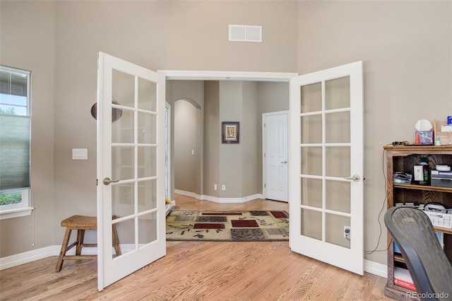 14879 Xenia St, Thornton, CO 80602 - office with french doors, arched walkways, wood finished floors, and baseboards