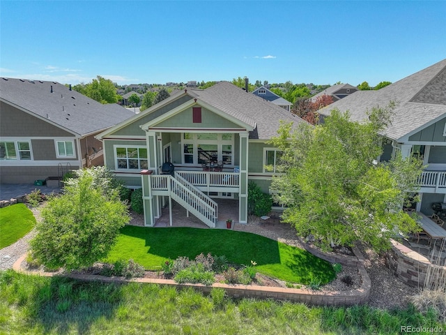 14879 Xenia St, Thornton, CO 80602 - view of front of home with a front yard, a shingled roof, stairs, and a porch
