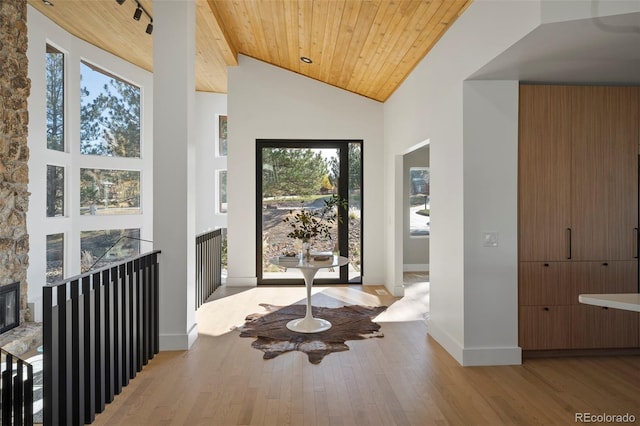 foyer entrance featuring high vaulted ceiling, hardwood / wood-style flooring, and wooden ceiling