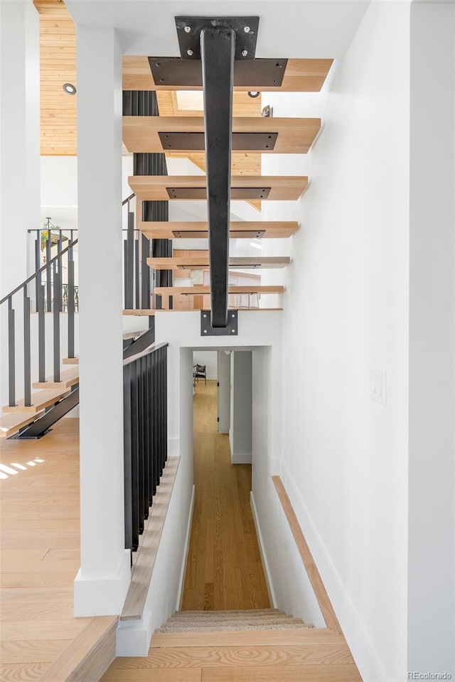 stairway featuring wood-type flooring