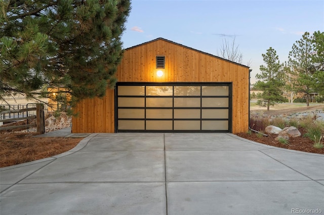 view of garage at dusk