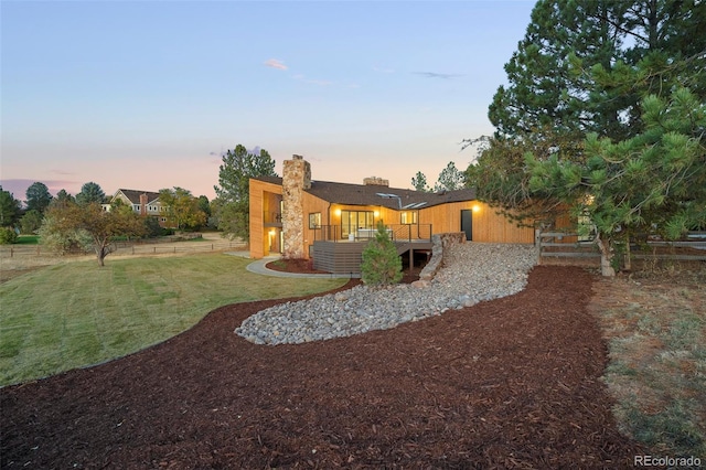 yard at dusk with a wooden deck