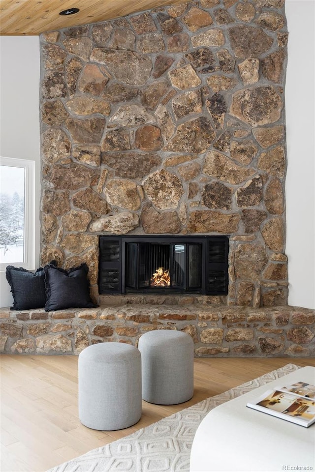 interior details with a fireplace, wood-type flooring, and wood ceiling