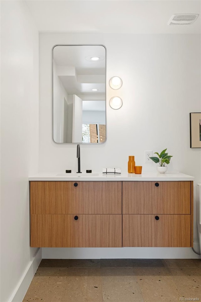 bathroom featuring vanity and toilet