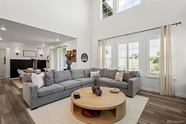 17121 Desert Wine Ln, Parker, CO 80134 - living room with dark wood-type flooring, baseboards, recessed lighting, and a towering ceiling