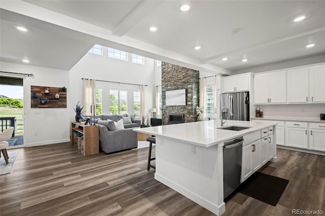 17121 Desert Wine Ln, Parker, CO 80134 - kitchen featuring appliances with stainless steel finishes, a sink, light countertops, white cabinetry, and beam ceiling