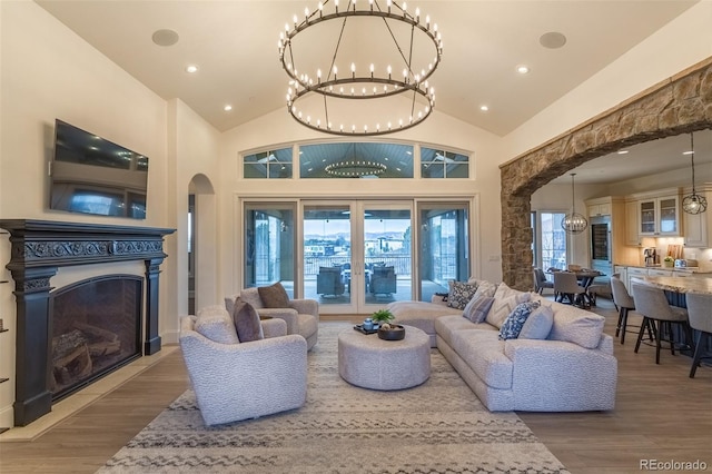 living room with lofted ceiling, plenty of natural light, and wood-type flooring