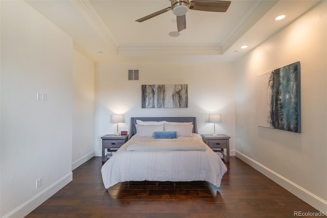 bedroom featuring ceiling fan, a raised ceiling, ornamental molding, and dark hardwood / wood-style flooring