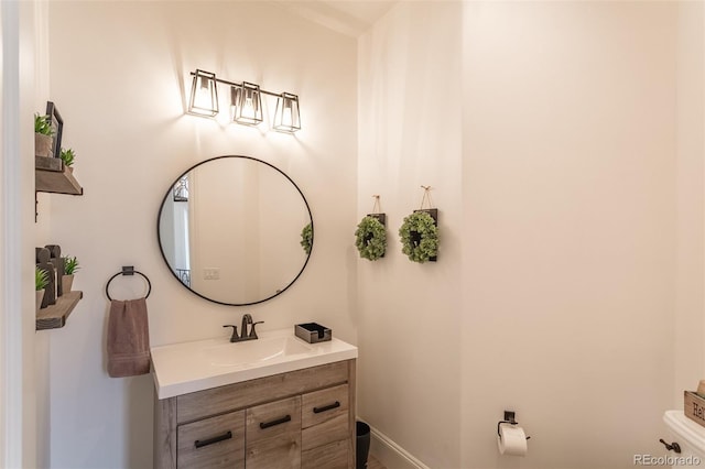 bathroom with toilet and vanity