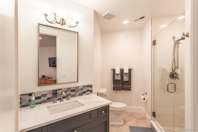 bathroom featuring tile patterned flooring, toilet, walk in shower, and vanity