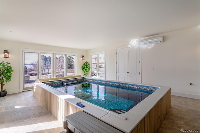 view of pool with an indoor hot tub and a wall mounted air conditioner