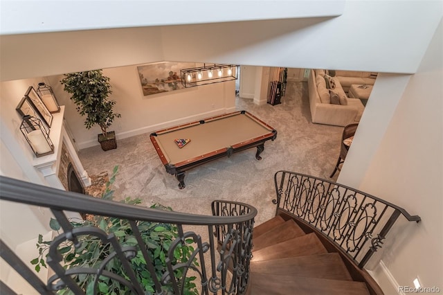 stairs featuring pool table and carpet floors