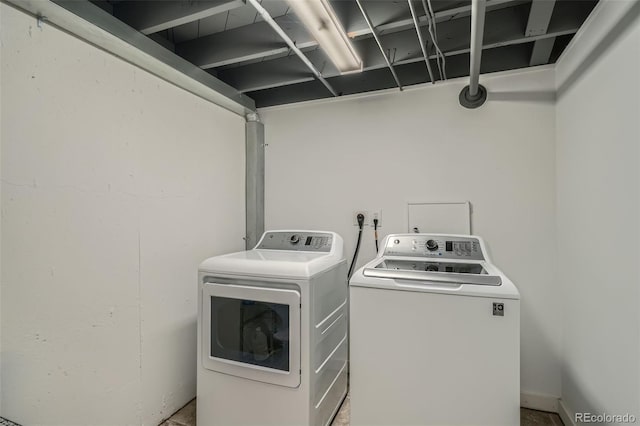 washroom featuring laundry area and washing machine and clothes dryer