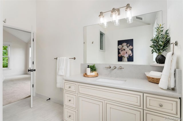 13483 Alcott Way, Broomfield, CO 80020 - bathroom featuring vanity, baseboards, and lofted ceiling