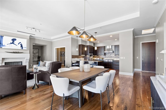 dining space featuring wood-type flooring and ornamental molding