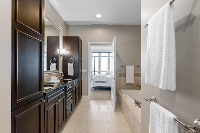 bathroom with vanity, tiled bath, and tile patterned floors