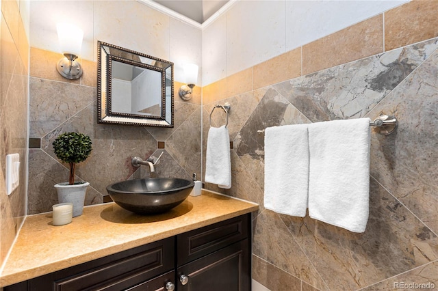 bathroom featuring vanity, tile walls, and ornamental molding