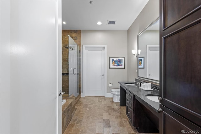 full bathroom featuring separate shower and tub, vanity, and toilet