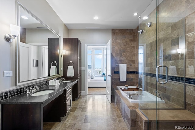 bathroom featuring vanity, tile walls, and independent shower and bath