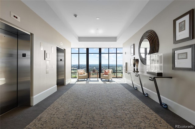 hallway featuring dark colored carpet and elevator