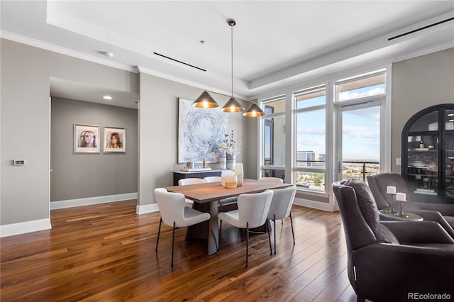 dining area with dark hardwood / wood-style flooring and ornamental molding