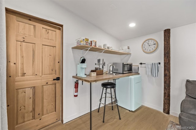 kitchen with wooden counters and light wood-type flooring