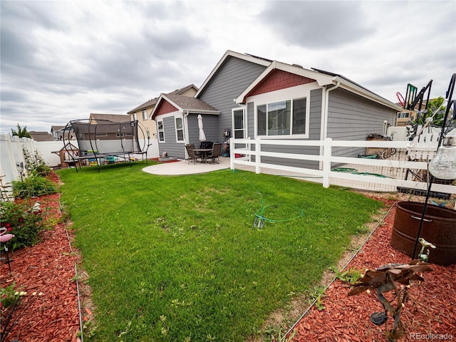8809 15th Street Rd, Greeley, CO 80634 - rear view of house with a trampoline and a patio area
