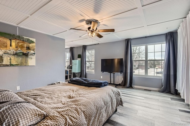 bedroom featuring multiple windows, ceiling fan, and light hardwood / wood-style floors