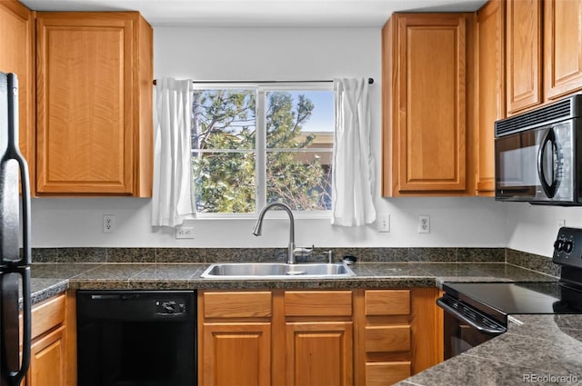 kitchen featuring sink, black appliances, and plenty of natural light