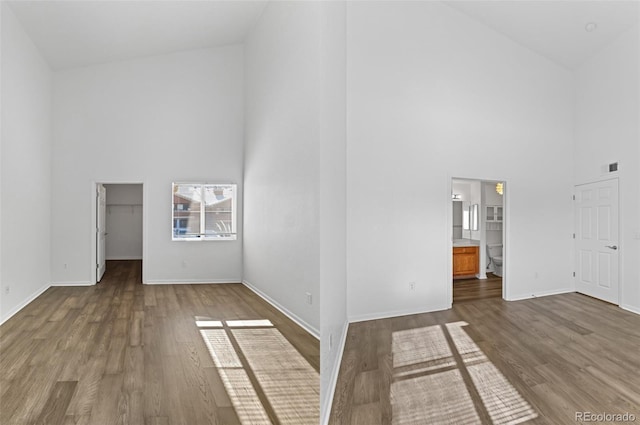 empty room featuring hardwood / wood-style flooring and high vaulted ceiling