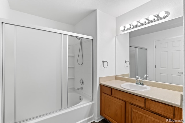 bathroom with shower / bath combination with glass door and vanity