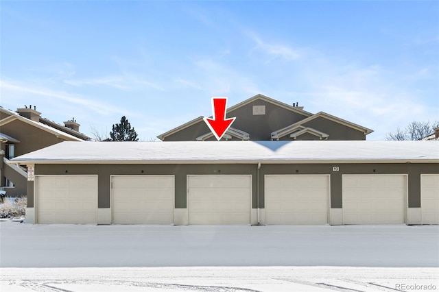 view of snow covered garage