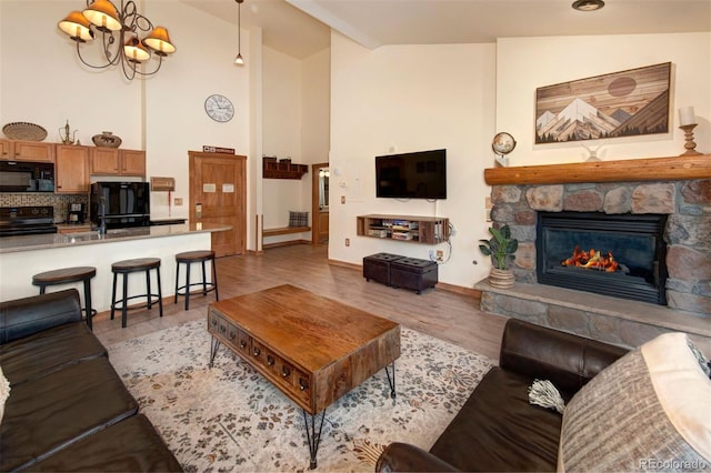 91 River Run Rd Unit 8140, Keystone, CO 80435 - living area featuring high vaulted ceiling, a fireplace, light wood-type flooring, and baseboards