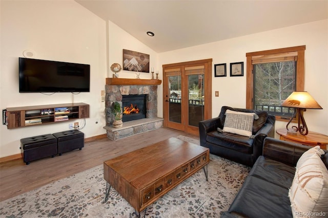 91 River Run Rd Unit 8140, Keystone, CO 80435 - living room featuring wood finished floors, lofted ceiling, a fireplace, and baseboards