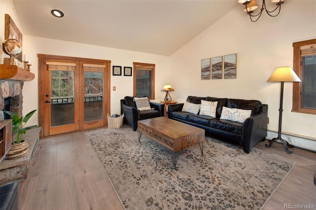 91 River Run Rd Unit 8140, Keystone, CO 80435 - living room featuring french doors, vaulted ceiling, wood finished floors, recessed lighting, and a stone fireplace