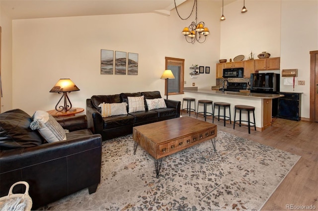 91 River Run Rd Unit 8140, Keystone, CO 80435 - living room featuring light wood finished floors, high vaulted ceiling, and a chandelier