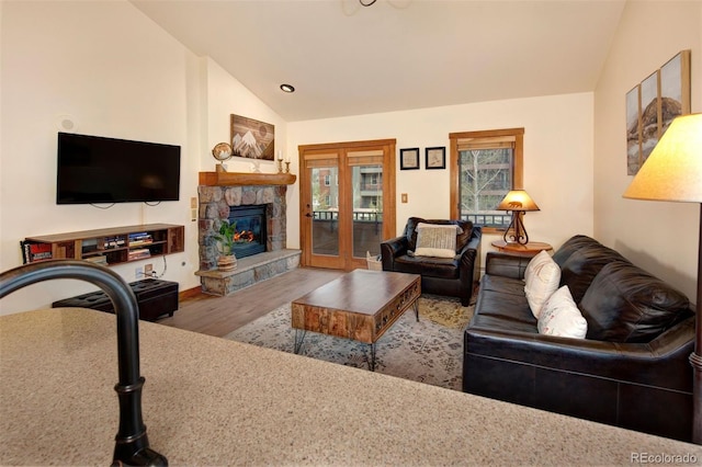 91 River Run Rd Unit 8140, Keystone, CO 80435 - living area with lofted ceiling, wood finished floors, french doors, a stone fireplace, and baseboards