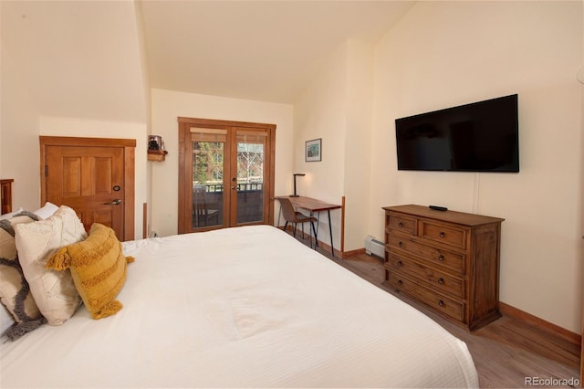 91 River Run Rd Unit 8140, Keystone, CO 80435 - bedroom featuring access to exterior, wood finished floors, baseboards, and a baseboard heating unit