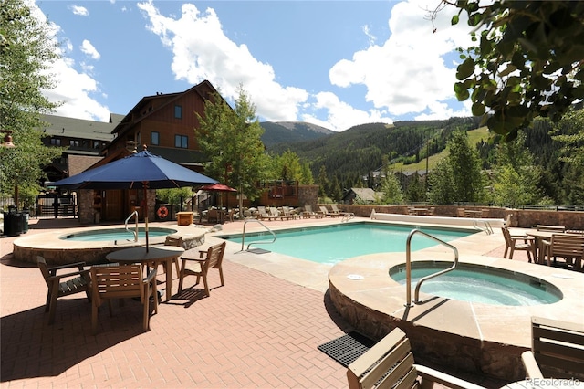 91 River Run Rd Unit 8140, Keystone, CO 80435 - community pool featuring a hot tub, a mountain view, and a patio