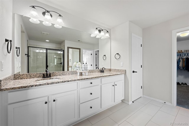 bathroom with vanity, tile patterned floors, and a shower with shower door