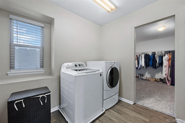 washroom with dark hardwood / wood-style floors and washing machine and clothes dryer