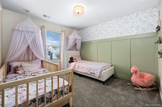 bedroom featuring dark colored carpet