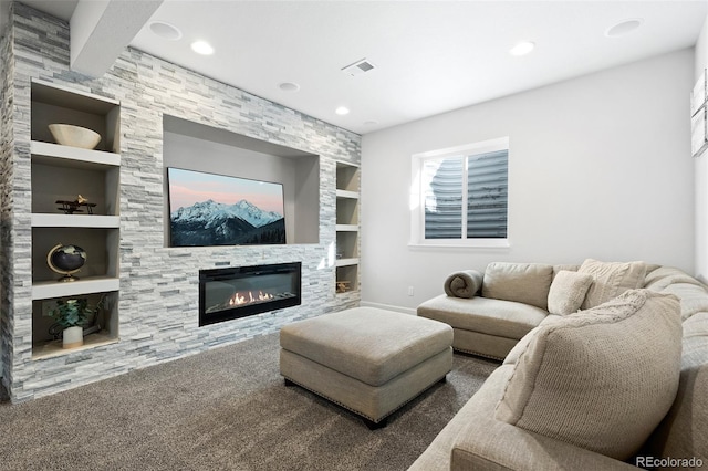 carpeted living room with beamed ceiling, built in shelves, and a fireplace