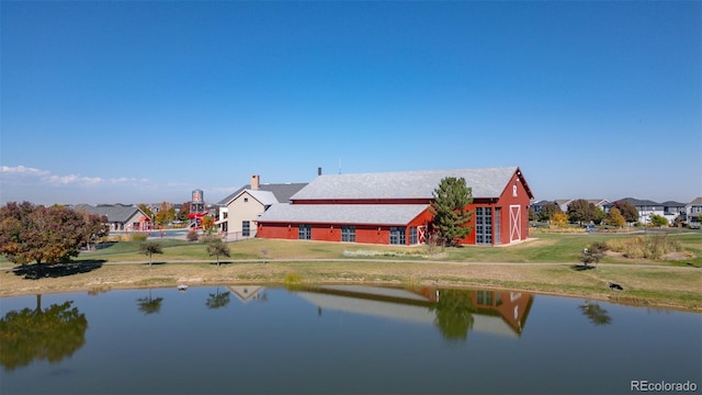 back of property with a water view