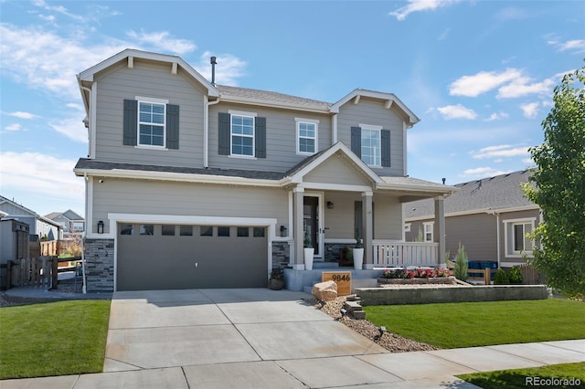 craftsman inspired home featuring a front lawn, covered porch, and a garage