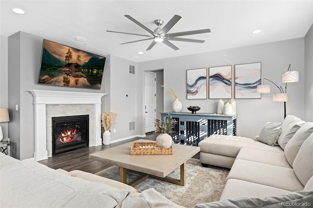 living room with wood-type flooring and ceiling fan